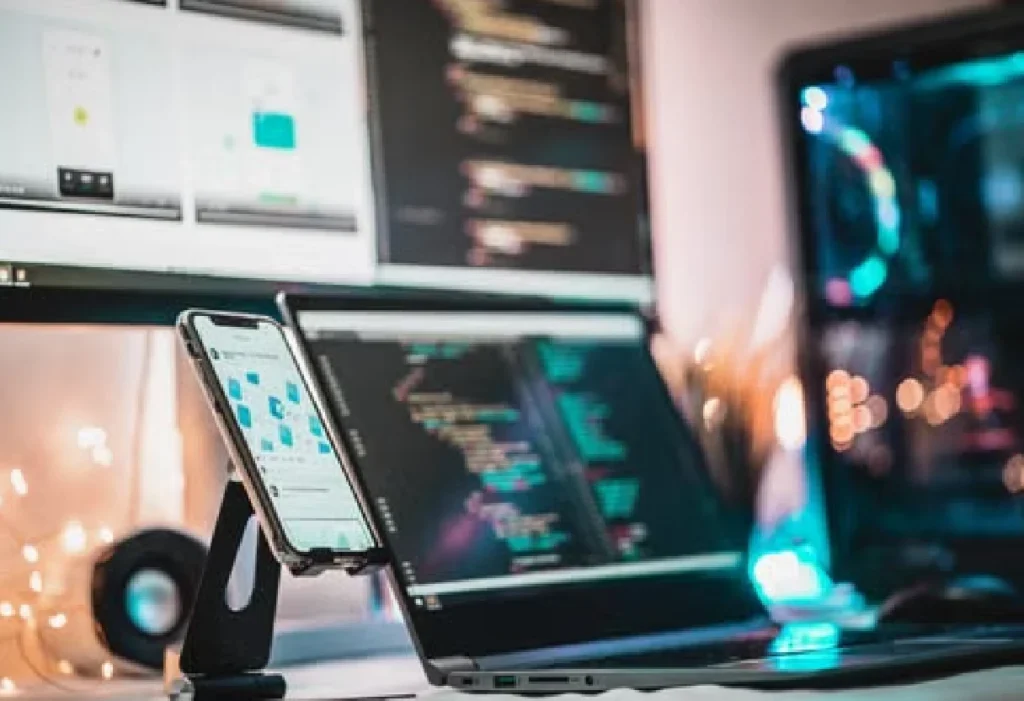 Developer working with code on multiple screens