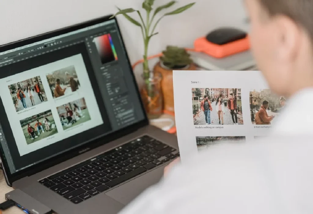 Designer reviewing a photo layout on a laptop