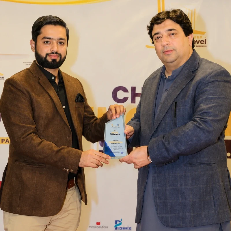 Home 68 Waqas Javed Satti receiving a professional award from Hasham Sarwar at an industry event.
